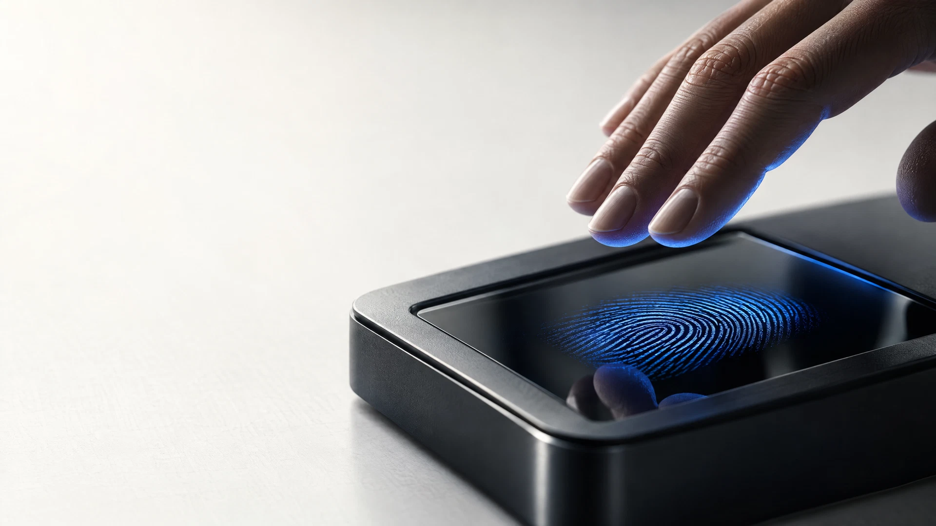 A hand poised above a modern fingerprint scanning surface